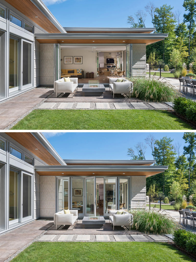 Off to the side of the main living area in this modern house is a second, more casual living room and small dining area. This casual area has folding glass doors that opens up to an outdoor lounge with fire table.