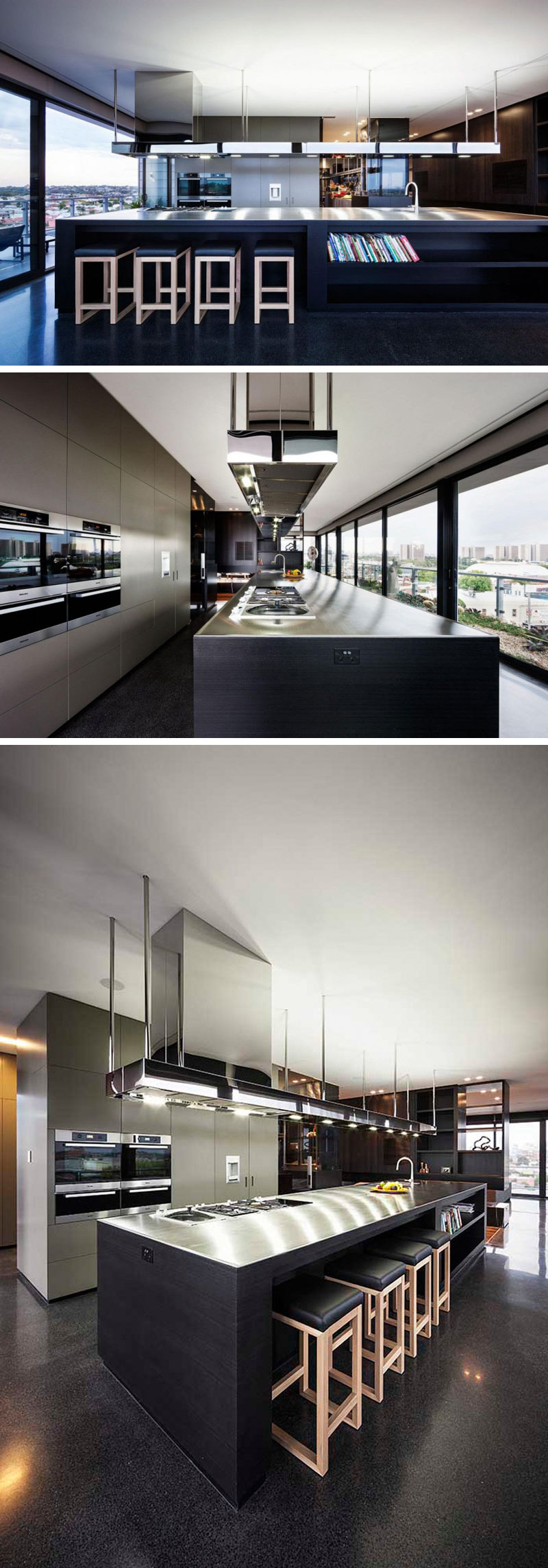 In this modern kitchen, a large black and stainless steel island is featured with built-in shelving for cookbooks. Light grey cabinetry compliments the colors used throughout the home and equips the space with storage.