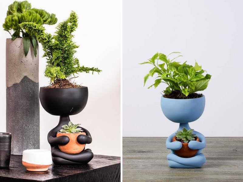 These modern black and blue ceramic planters are crossed legged and zen like, holding their potted plants close. 