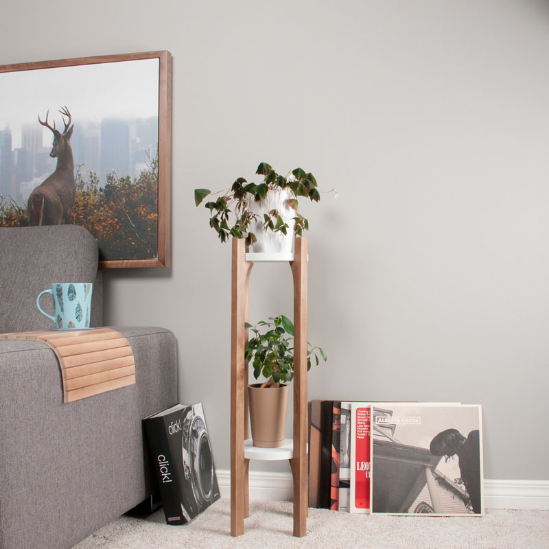 This modern walnut wood plant stand is two tiered with white shelves to hold multiple plants. #PlantStand #ModernPlantStands #Garden #Plants #ModernHomeDecor