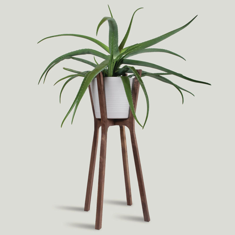  Made for indoor use only, this handmade modern walnut wood plant stand is perfectly designed for holding your plants that can't be outside.  #PlantStand #ModernPlantStands #Garden #Plants #ModernHomeDecor