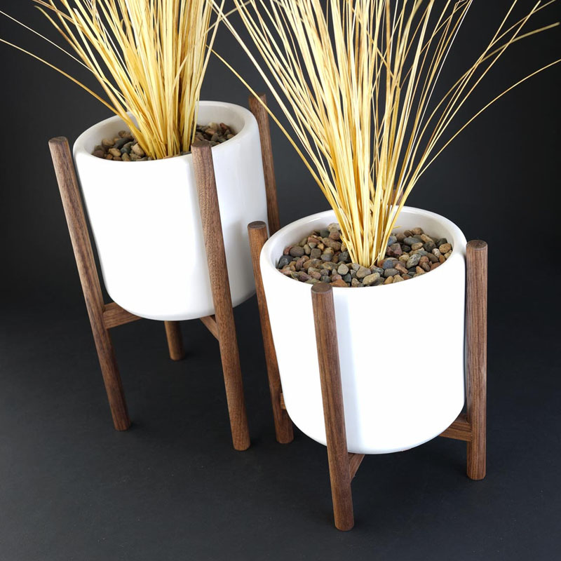 Cylinder shaped white ceramic pots sit inside these staggered walnut wood plant stands. Mid-century inspired, these modern plants stands would suit for any home decor.  #PlantStand #ModernPlantStands #Garden #Plants #ModernHomeDecor