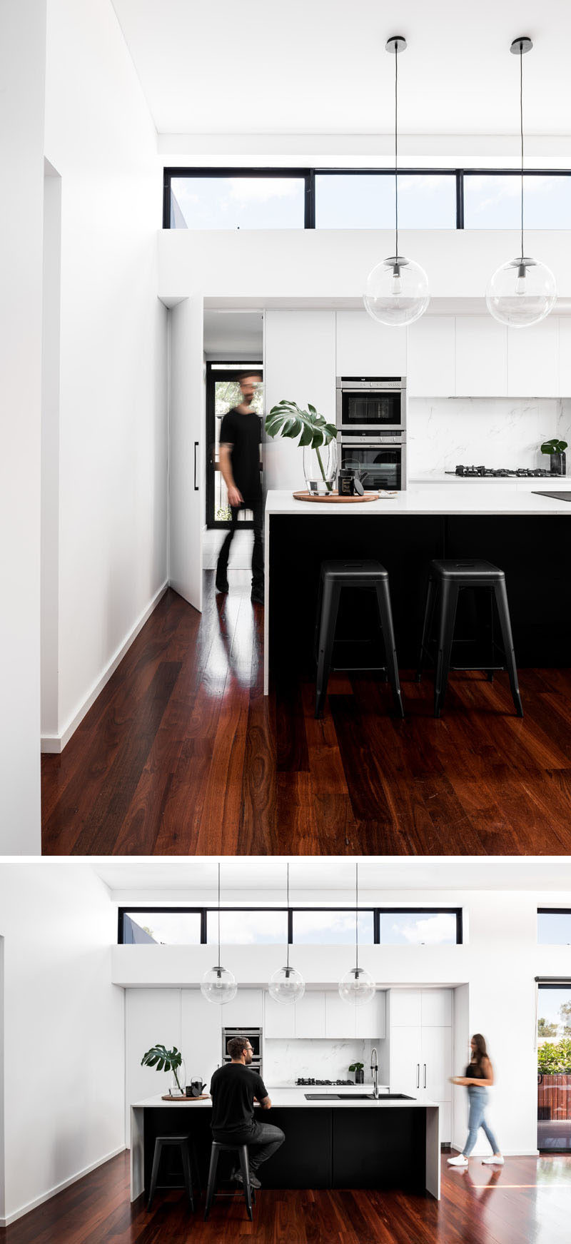 This new kitchen has white cabinets and a stone backsplash, while the island features a black base that ties in with the black window frames.