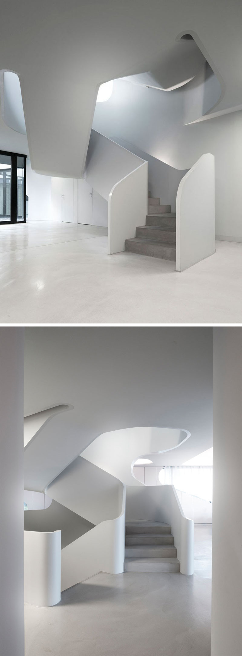 Entering into the home, a sculptural white set of stairs with smooth concrete steps leads you to the second floor of this modern house.