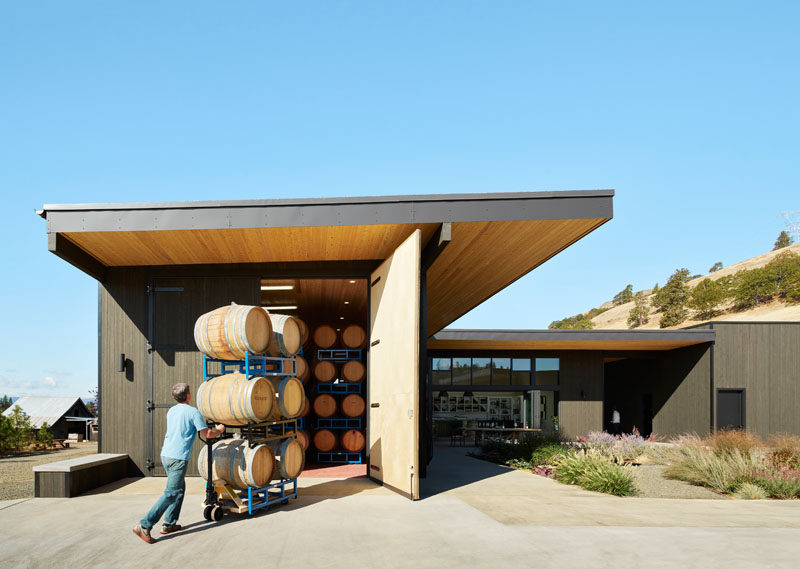 This modern winery courtyard is surrounded by buildings that house the wine barrels, allowing visitors to see and experience the every day workings of the winery.