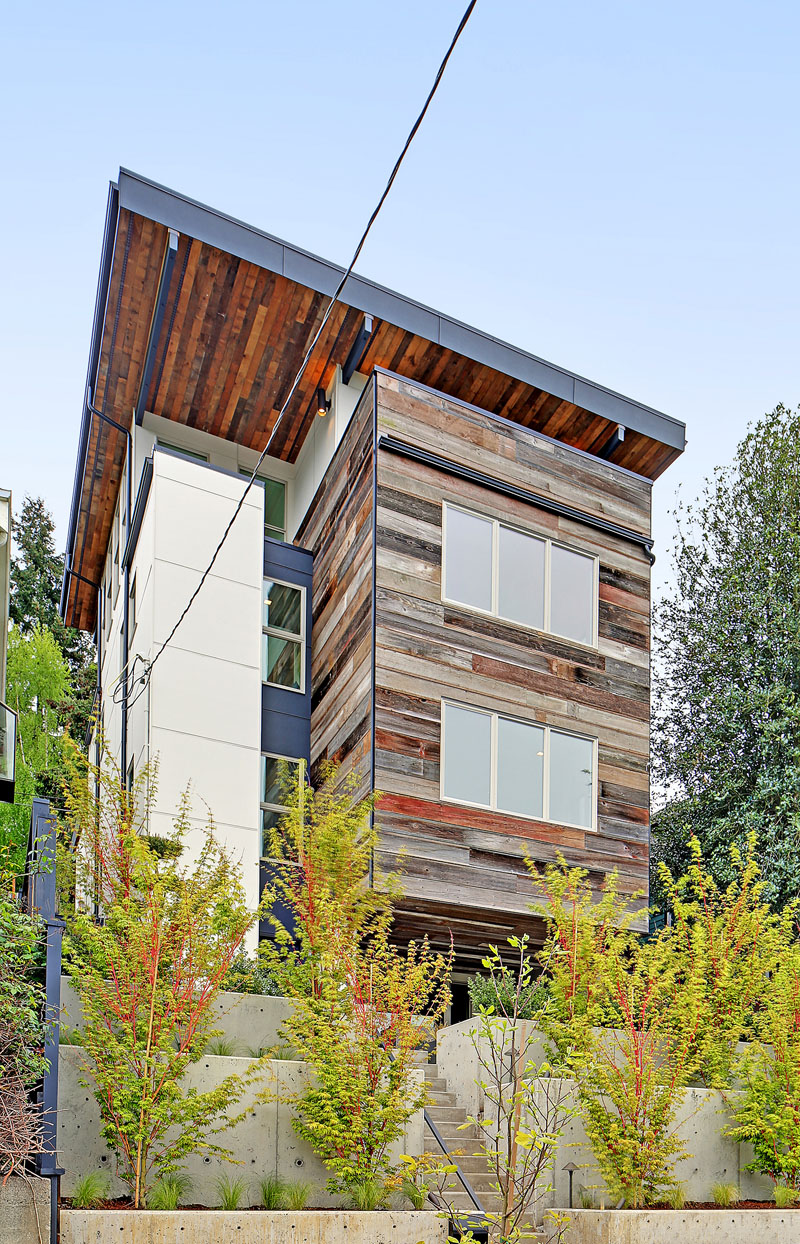  The exterior of this modern house is adorned with reclaimed barn wood in various hues, and metals sourced from Oregon.