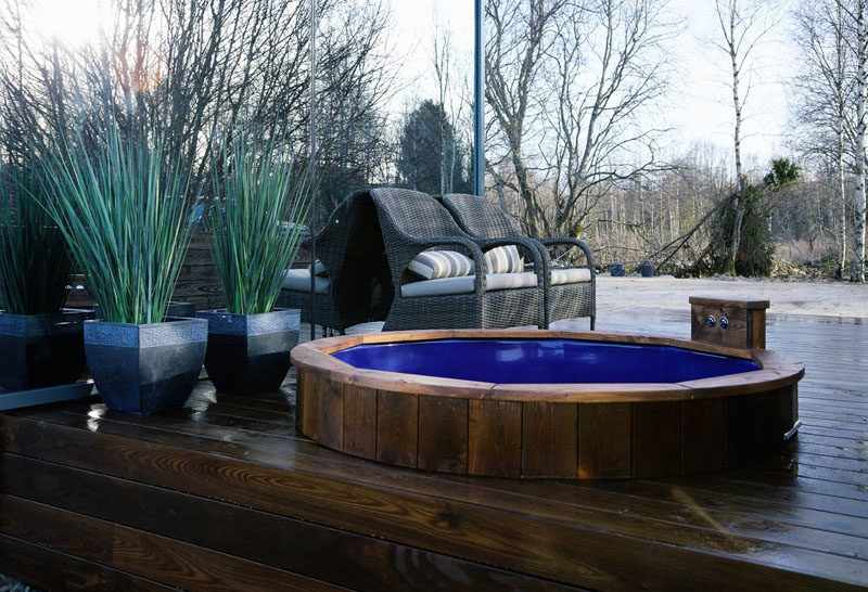 Out on this modern wood deck, there is a built-in hot tub to jump into while enjoying the outdoors.