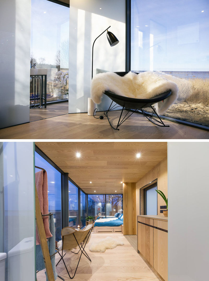 A black chair and a white and black floor lamp at the end of this modern hallway provides a nice place to read and relax. 