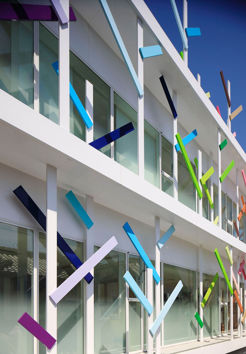 On the facade of this modern kindergarten in Japan are 63 white trees that are 13 ft (4m) high that are covered in colorful branches that wrap the building. 22 colors have been used to create the fun facade.