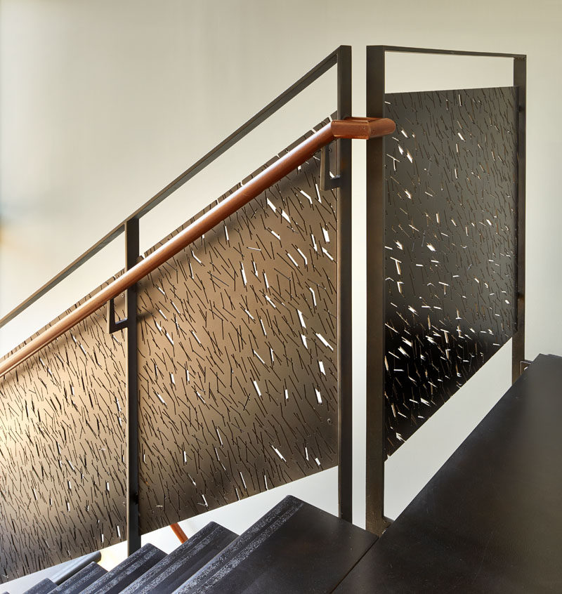 These modern stairs have custom-designed steel railing panels that provide shadow patterns in the stairwell when the sun hits them in the late afternoon.