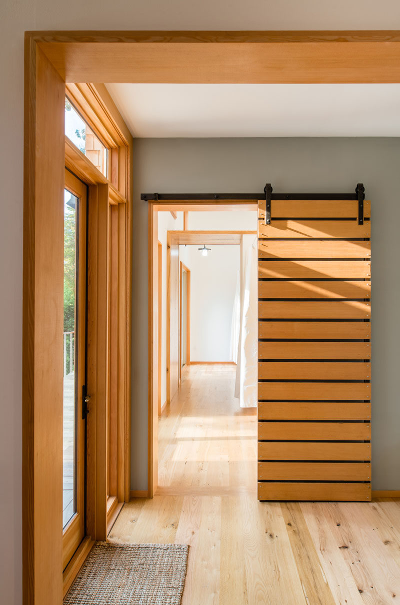 This sliding wood barn door separates a couple of bedrooms from the rest of the house.