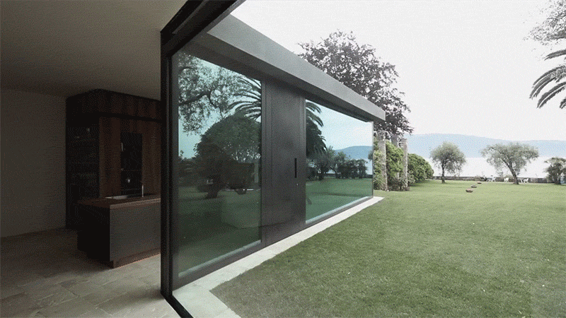 Bergmeisterwolf have designed a modern extension for a house in Italy that features vertical sliding windows that can disappear into the ground.