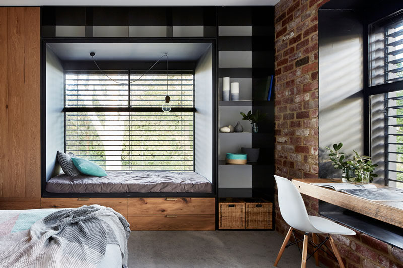 The steel windows on the exterior of this modern house also push into the bedrooms, where futon mattresses are used as day beds to create the ideal built-in nook.