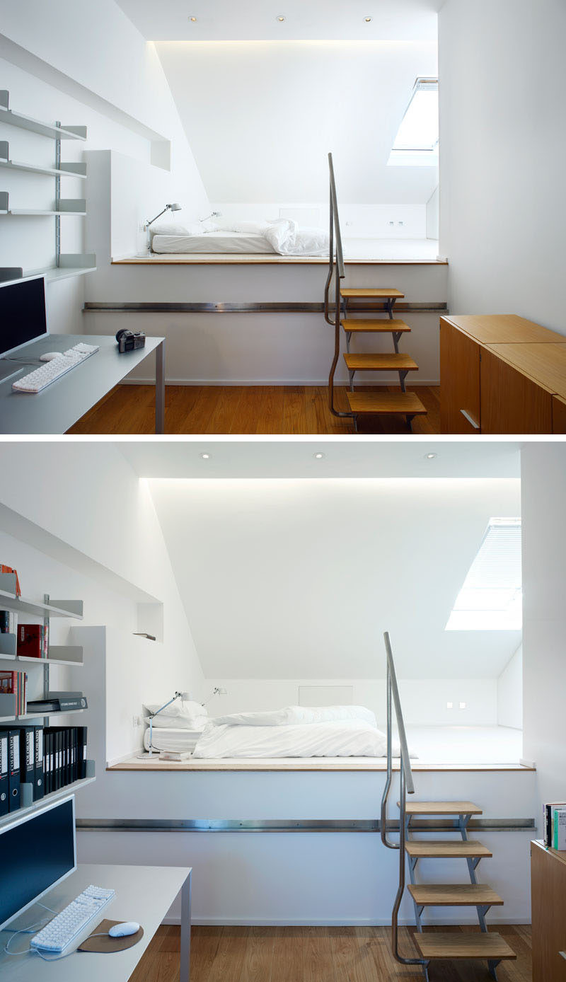 In this modern bedroom, the bed sits on a raised platform that is reached by climbing a set of small wood and stainless steel stairs.