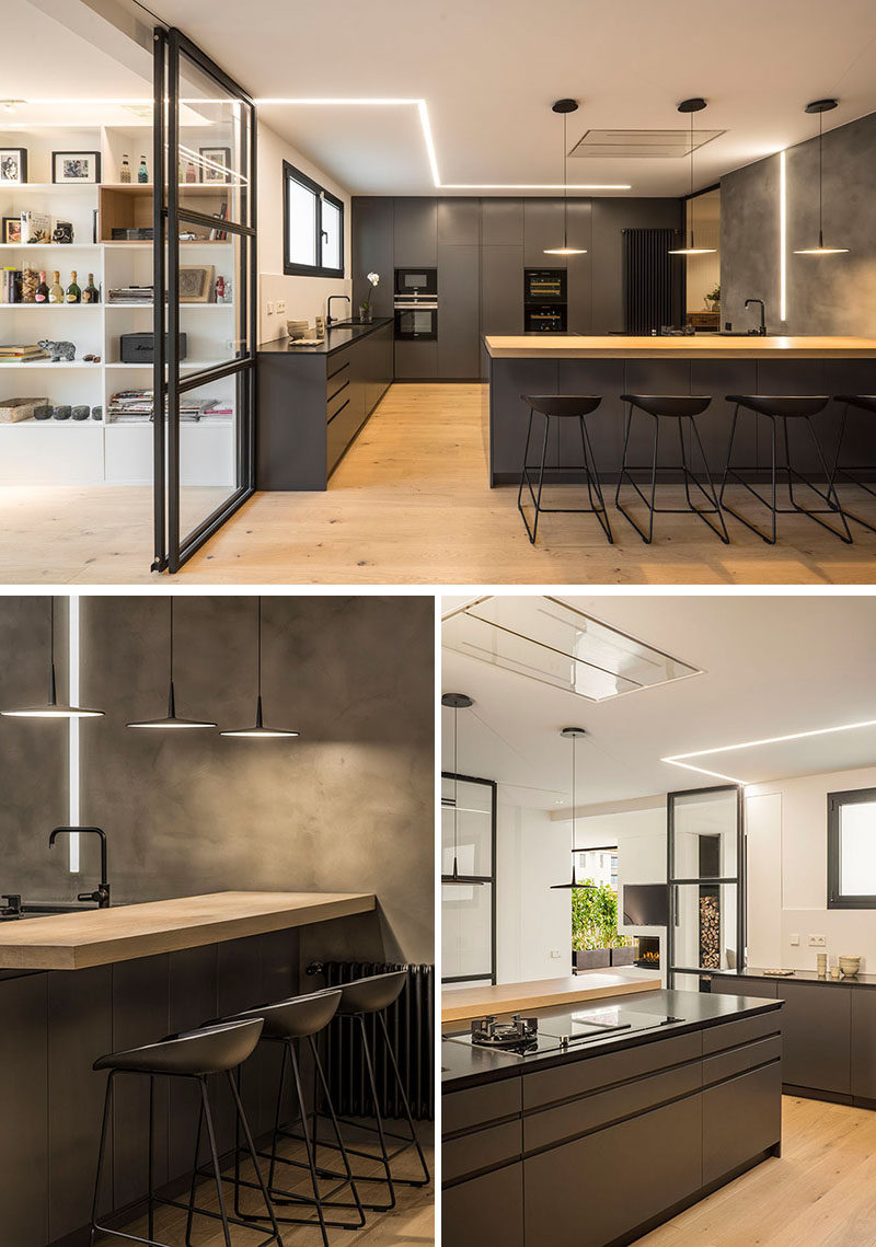 A line of light travels from the living room to the kitchen in this penthouse and creates an interesting visual effect. Grey cabinets have been paired with black and wood countertops for a contemporary appearance.
