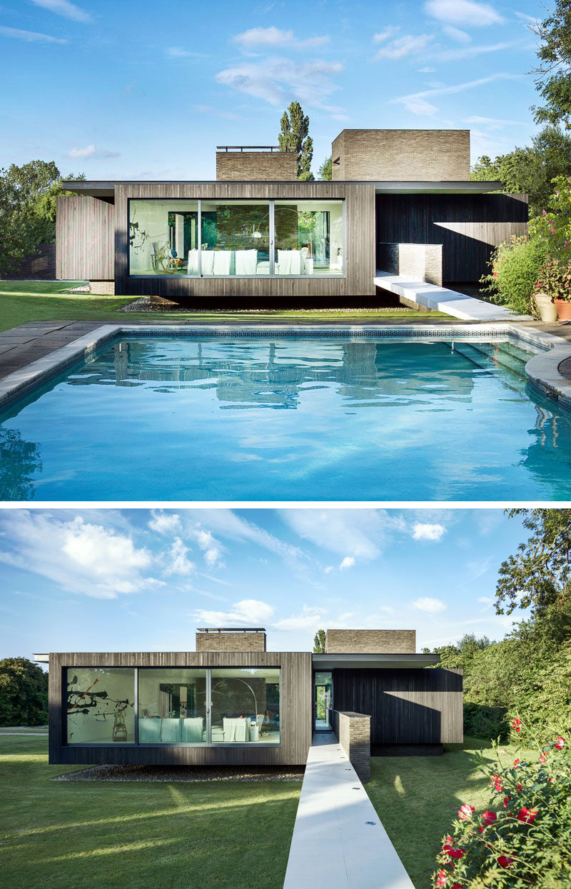 This modern house has a swimming pool that's connected to the house via a small bridge.