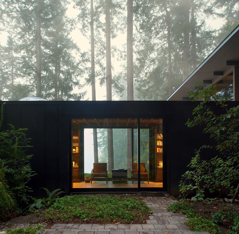 This modern cabin in the forest has grown over the years from a simple bunkhouse to a full retreat with multiple bedrooms for family and friends.