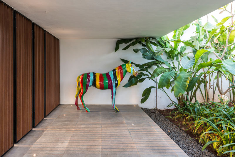 A horse sculpture adds a pop of color to this modern house.