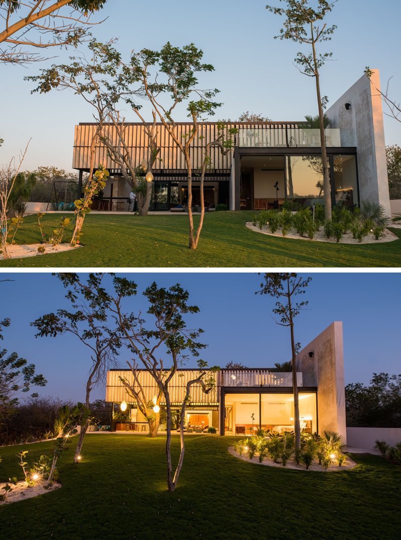 The back of this modern house opens up to a large landscaped backyard.