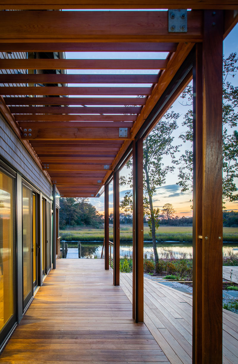 A small wood porch, with doors that open onto it, wraps around the exterior of the house.