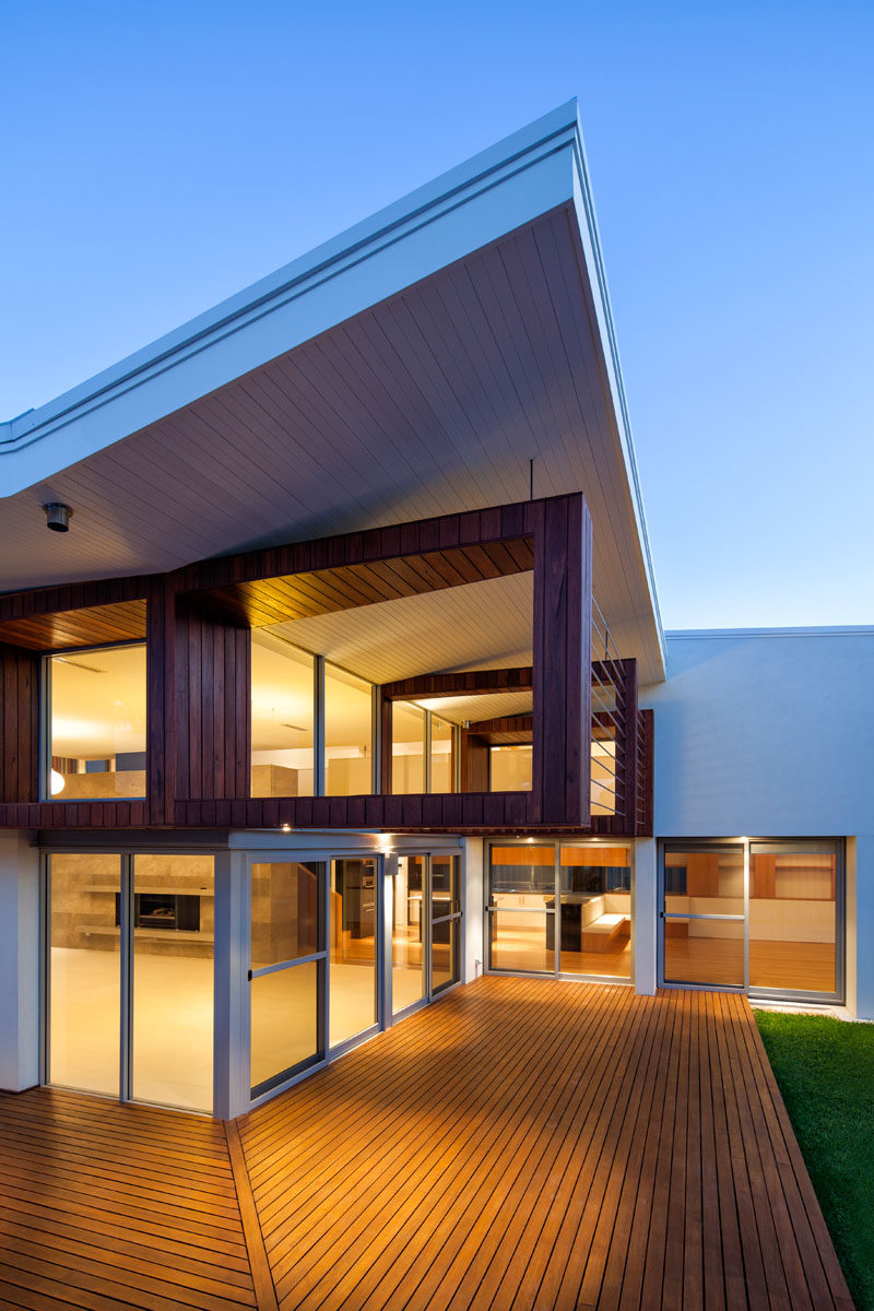 The house has a sloped roof and an outdoor wood deck for alfresco dining.