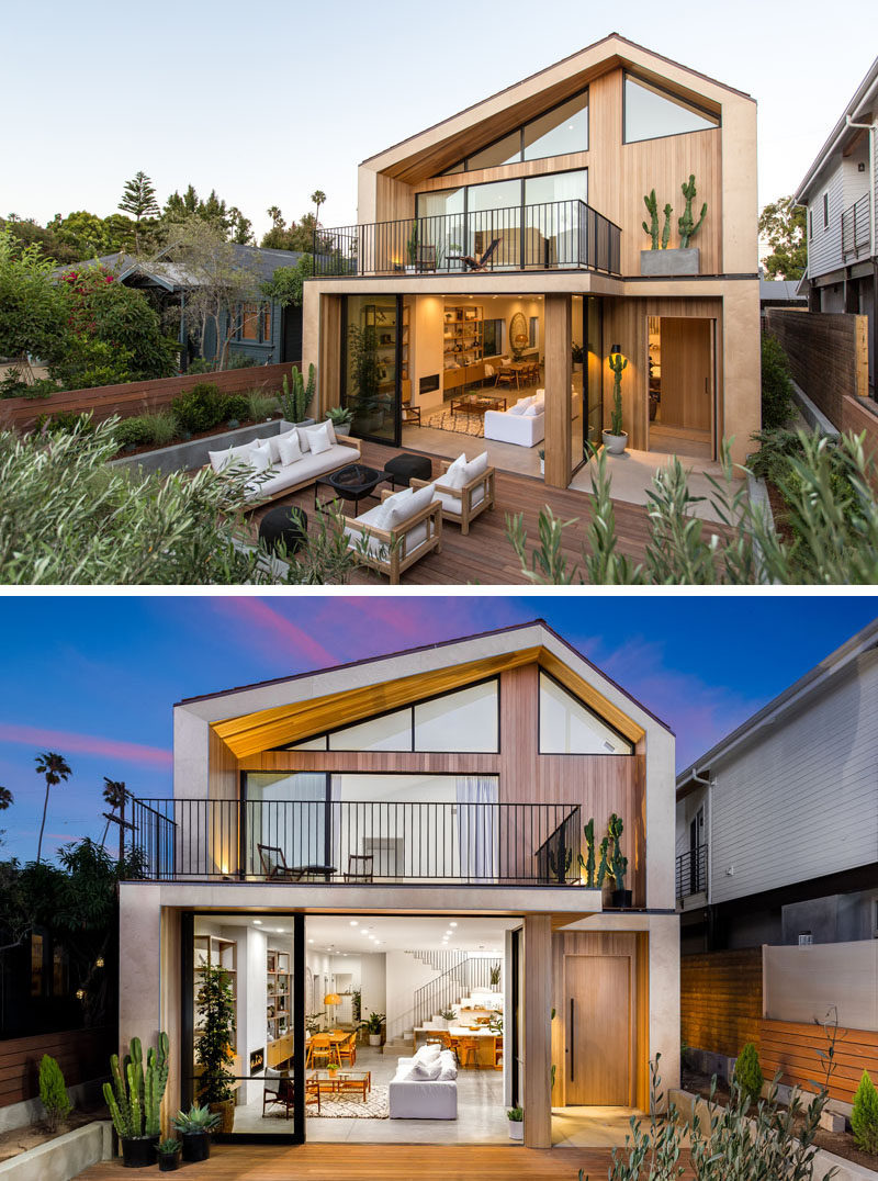 At the front of this modern house, there's an outdoor living area that's surrounded by mature landscaping.