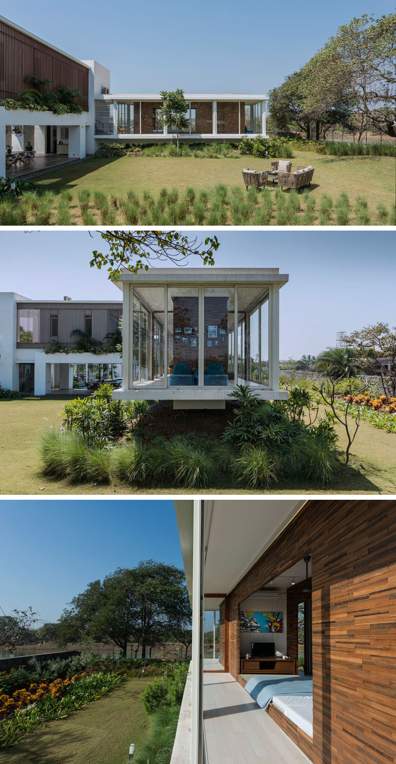 For the children that live in this modern house, there's a special area just for them, a cantilevered room that features a wood box within a glass box. This cantilevered space has large floor-to-ceiling windows that look out onto the garden.