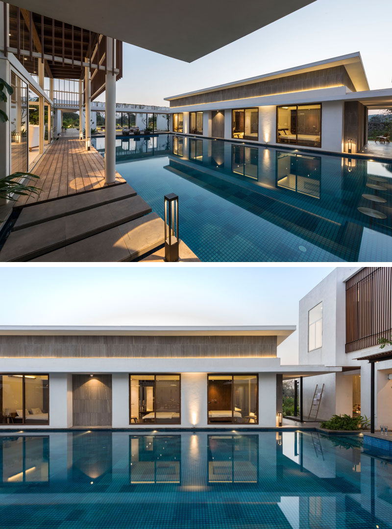 The living spaces and bedrooms of this modern house are located on either side of the swimming pool.