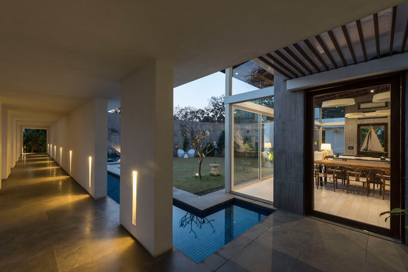 The entry hallway of this modern house is designed to allows the sun to shine through during the day, and at night, it can be lit up for a more dramatic entrance.