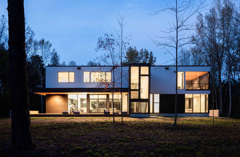 At the rear of this modern house there's plenty of windows and an overhang covers an outdoor entertaining area. 