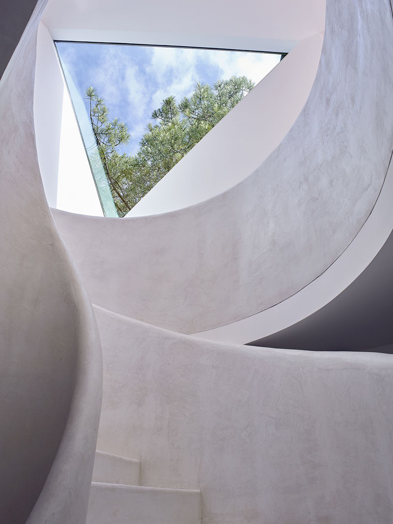 This triangular window provides plenty of natural light to this curved stairwell.