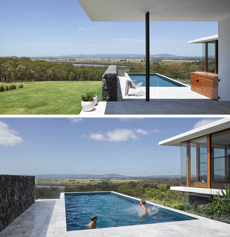 This modern house has a covered outdoor area that provides access to the swimming pool, that has an amazing view of the landscape and mountains in the distance.