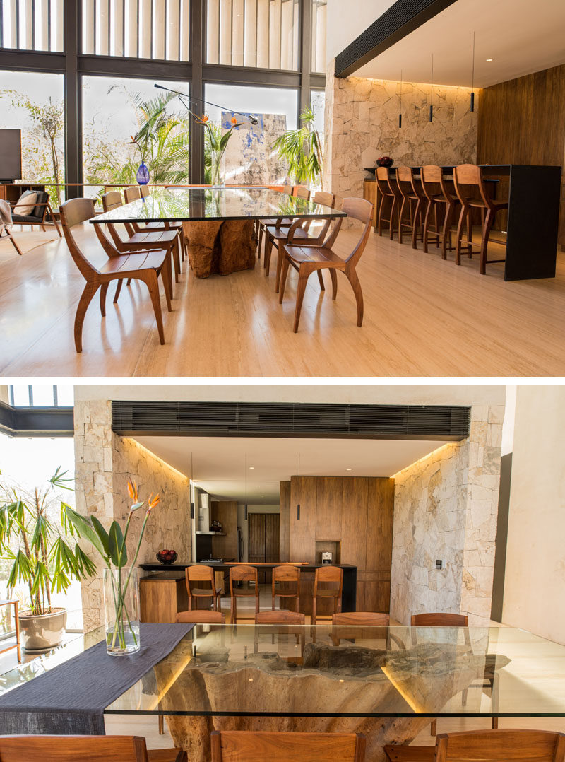 This modern dining area features a glass table top that allows the wood base to be seen, and at the same time, keeps the interior feeling light.