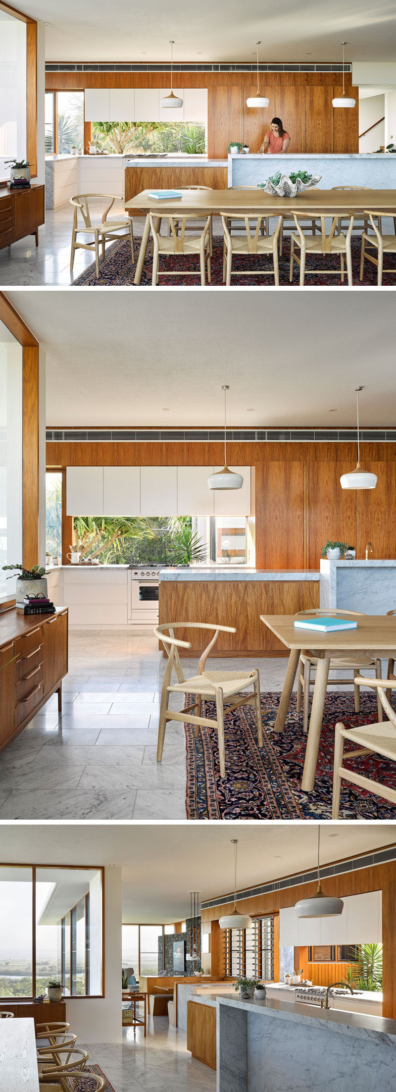 This modern house features a kitchen with wood cabinets and marble countertops.