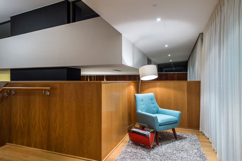 At the top of the stairs in this modern house is a small sitting area, ideal for relaxing and reading a magazine or book.