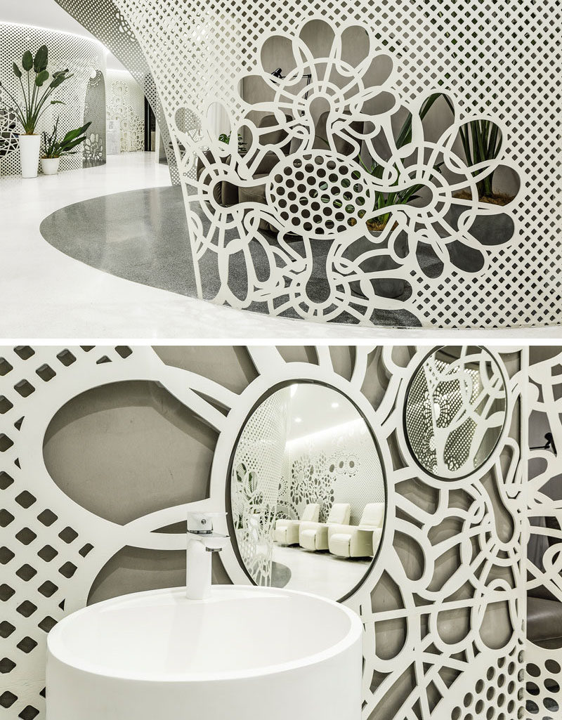 The delicate lace-like patterns featured in this modern nail salon, are created by laser-cutting 6mm steel plates that are then curved where required.