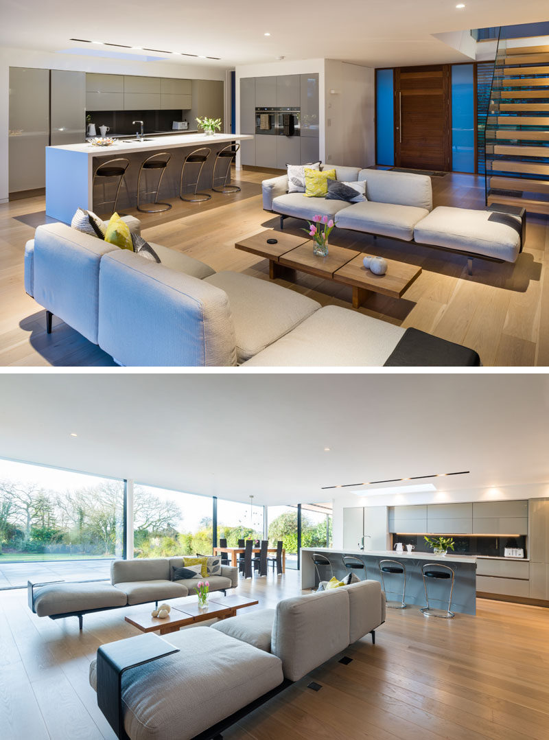 This modern house has an open floor plan on the main floor with the living room, dining room and kitchen all sharing the same space.