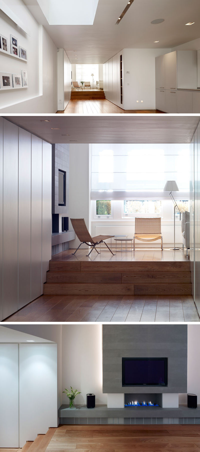 Next to the kitchen and dining area in this renovated house, there's a wide hallway that leads to a sitting room at the front of the property. A grey fireplace surround with an embedded tv breaks up the all white room.