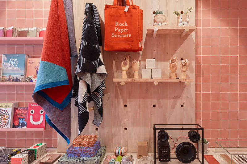 This modern retail store has a variety of shelving designs, like this simple wood pegboard wall shelf.