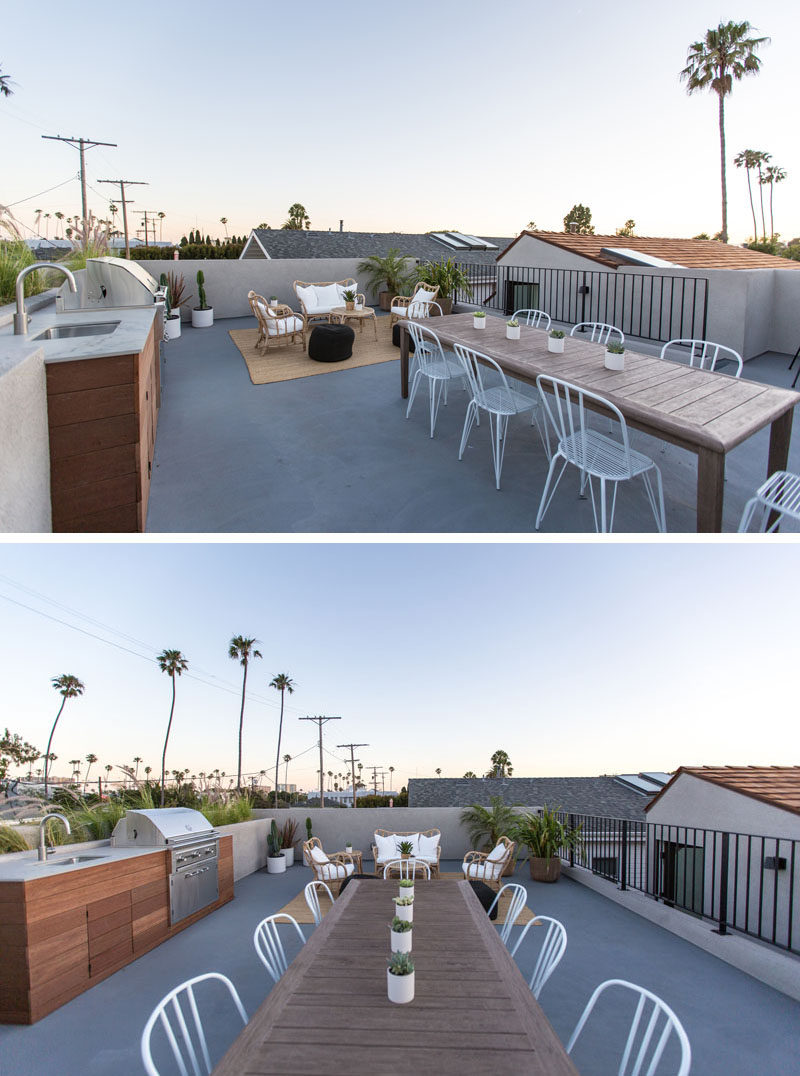 The roof of this modern house has been turned into a rooftop deck with a built-in outdoor kitchen with bbq, a lounge area and an dining area.