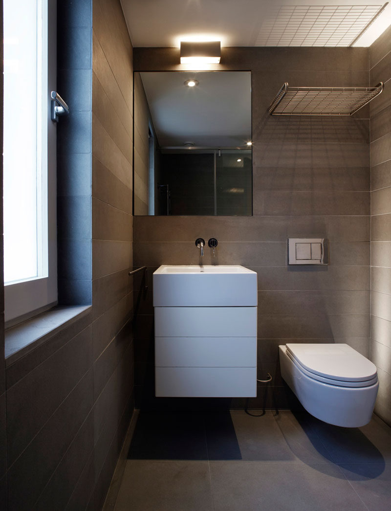 This small and modern bathroom features Pietra Serena Italian sandstone walls and floors.