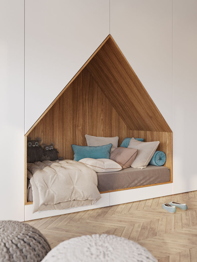 This modern bedroom design has a bed that's been built into a wall of floor-to-ceiling white cabinets.