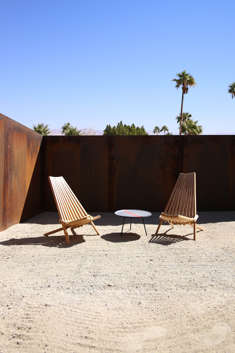 This patio is surrounded by a weathered steel fence. #patio #landscaping #fence #WeatheredSteel #ModernFence