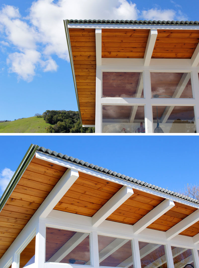 A modern potting shed with an angled roof made from from redwood decking and corrugated steel that allows rainwater to be collected. 