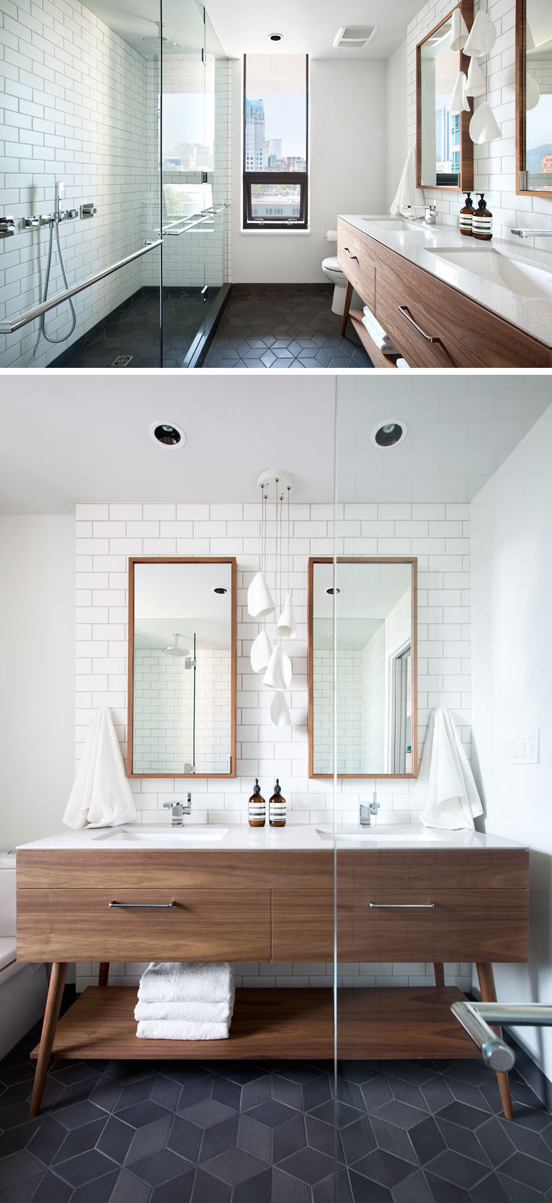 In this modern bathroom, a large glass enclosed shower takes up one wall, while a wood vanity with dual sinks and a white counter is featured on the opposite wall. White subway tiles have been used for the walls, and dark grey, geometric tiles have been used for flooring.