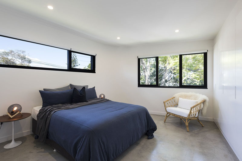 In this simple bedroom, furnishings have been kept minimal and glimpses of the sky and trees outside are visible through the black-framed windows. #Bedroom #Windows #Interiordesign