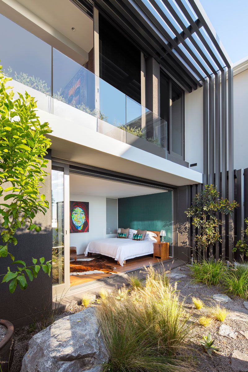 This modern bedroom opens up to a small private garden.