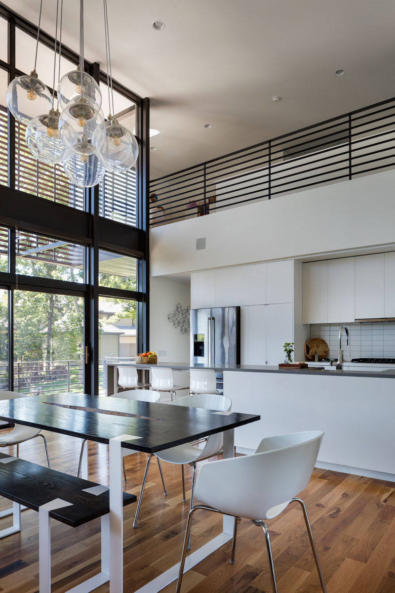 This dining table and chairs is anchored in the open plan room by a large chandelier that hangs from the ceiling. 