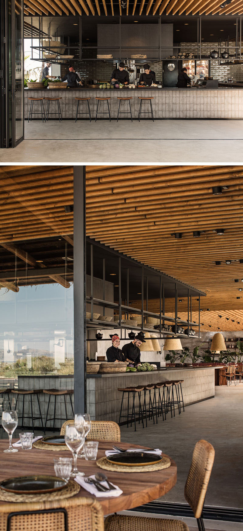 This hotel restaurant features an open-kitchen with black metal shelving that hangs from the ceiling. #Restaurant #RestaurantDesign #Hotel #InteriorDesign #Architecture