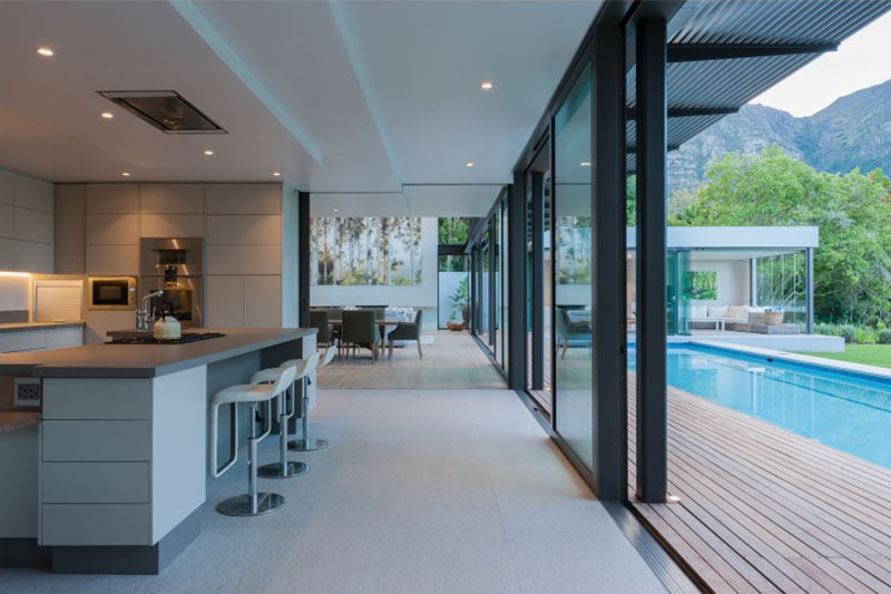 This modern kitchen has been designed around an AGA stove that sits in the middle of the kitchen island.